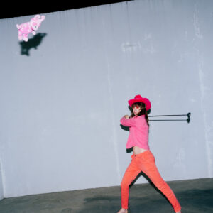 Pink Cowgirl swinging a teddy