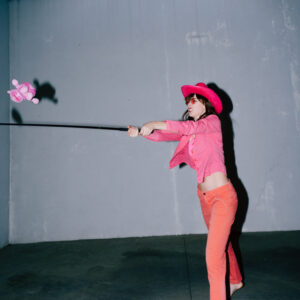 Pink Cowgirl swinging a teddy I